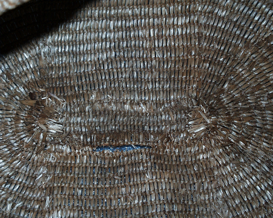 Hearst Museum object 4 of 4 titled Bag, accession number 2-4534, described as Bag of woven grass, along mouth strands of warp are brought together in little braids about 1 cm in length, spaced at intervals of 1.5 cm.  Made with grass in open twining (rye grass leaves).