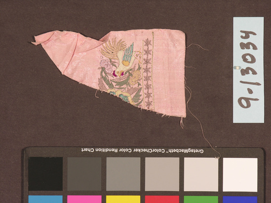 Hearst Museum object titled Textile fragment, accession number 9-13034, described as A fragment of cloth from a sari; made of pink silk with an embroidered varicolored rooster and floral motif with a line of stars below it. Length 21 cm.