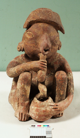 Hearst Museum object titled Figurine, accession number 3-3666, described as Red pottery effigy of seated man with bowl between feet, snake crawling from bowl to mouth