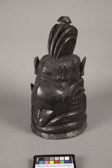 Hearst Museum object 3 of 4 titled Helmet mask, accession number 5-5834, described as helmet mask of West African gum wood blackened with shoe polish; anthromorphic with elaborate headdress and horns; height 42 cm