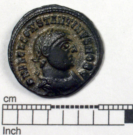 Hearst Museum object titled Coin: æ, accession number 8-5508, described as Coin; AE; Roman. 3.3 grams, 20 mm. Flavius Claudius Julius Constantine, 318-319 AD. Alexandria, Egypt. Obverse: D N FL CL CONTANTINES NOB C, bust laureate and cuirassed r., head of scepter at back of neck. Reverse: IOVI CONSERVATORI, Jupiter nude holding scepter surmounted by eagle with crown in beak, globe surmounted by Victory, at right foot an eagle holding a scroll, at left foot a kneeling figure; in field, X NE; in exergue, SRALA.