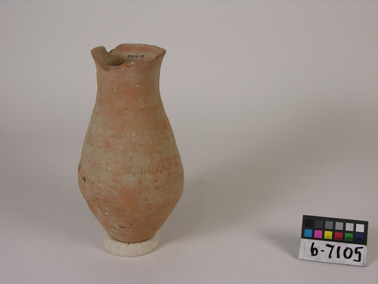 Hearst Museum object titled Broken jar, accession number 6-7105, described as Pottery: pinkish bottle shaped jar, rim broken, least diameter 8 cm, greatest diameter 14 cm, height 26 cm.