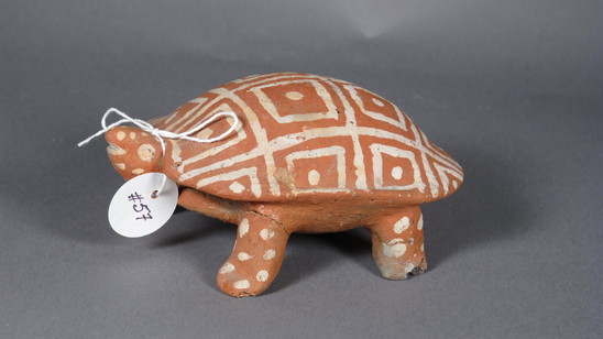 Hearst Museum object titled Turtle figurine, accession number 3-30434, described as turtle with four legs, head, and tail.  White painted square pattern on shell; head and legs with white spots.  stamped: Hecho en Mexico; in pencil "548".