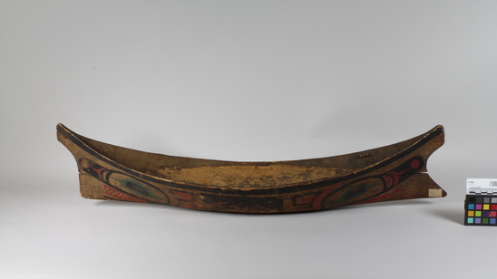 Hearst Museum object 2 of 6 titled Canoe model, accession number 2-10869, described as Model of canoe, painted totemic design in red, green, and black.  Wolf design (fide Charles Brown).