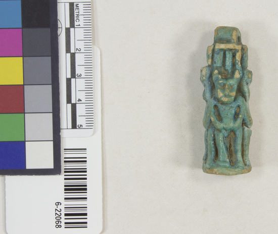 Hearst Museum object 3 of 11 titled Amulet (gods), accession number 6-22068, described as Four-sided amulet of blue faience, showing faience, showing Horus (two sides), Harpocrates, and Serket; length 56 mm.