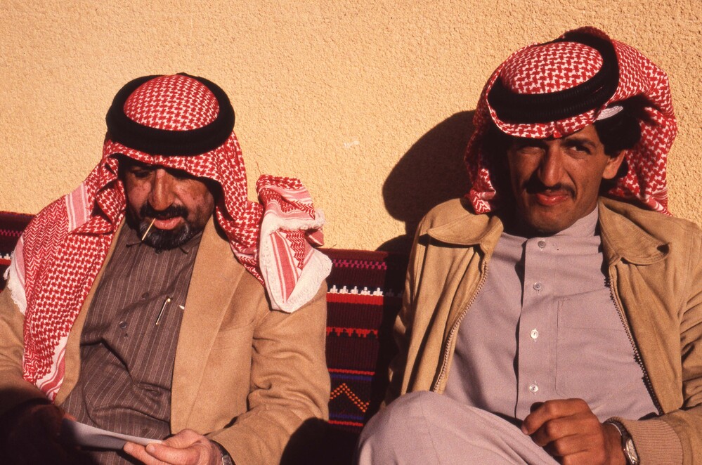 Hearst Museum object titled Color slide, accession number 25-99155, described as 35mm color slide transparency: "Oweisett + Abdul Mohsen". Portrait of 2 men sitting in front of a patterned cushion.