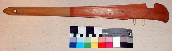 Hearst Museum object titled Spear-thrower, accession number 2-16686, described as Painted with ochre and Vivianite. Spruce, two ivory pegs, one-half stained red.