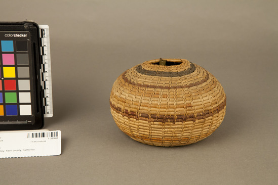 Hearst Museum object 2 of 2 titled Basket, accession number 1-20940, described as Jar basket; coiled. Warp is Epicampes (Sporobolus rigens), weft is Willow (Salix). Black pattern is Brake fern (Pteridium aquilinum). Red pattern is Yucca. Interrupted stitch. Decoration of 1 black and 5 simple red bands.