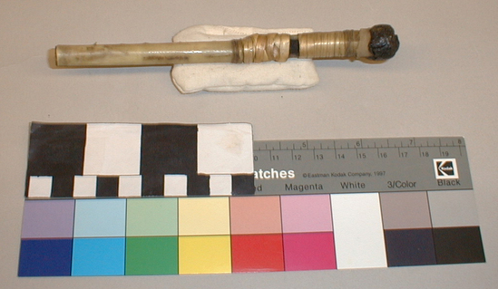 Hearst Museum object 4 of 4 titled Whistle, accession number 1-9304a,b, described as Bone, wrapped in natural color fiber in bands near center. Black mastic plug at distal end. (a) joined to (b) by leather thong.