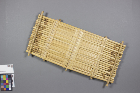 Hearst Museum object 1 of 2 titled Zither, accession number 5-7673, described as Zither, cane; a series of tied tules with stretched reeds which when plucked create a sounds. Length 43 cm; width 15 cm