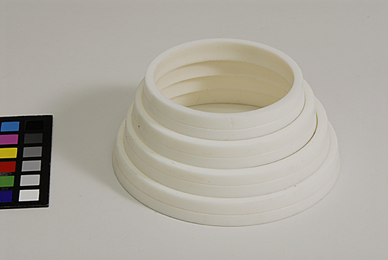 Hearst Museum object titled Bangles, accession number 9-22465a-d, described as plastic bangles; set of 4, graduated in size.  each bangle bisected by an inscribed line around the outer circumference.  ivory colored. Bag of string with objects, 5/24/12, AT.