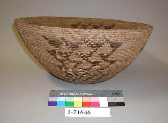 Hearst Museum object titled Basket, accession number 1-71646, described as Coiled; wide mouth with sloping sides. Decoration: 4 groups of geometrical brown designs featuring triangular forms. Made with cladium root. 3-rod coiling with interlocking stitches.