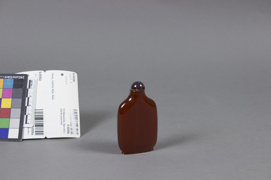 Hearst Museum object titled Snuff bottle, accession number 9-5550a,b, described as Snuff bottle; imitation amber; amethyst stopper glued in; height 2 7/8 in