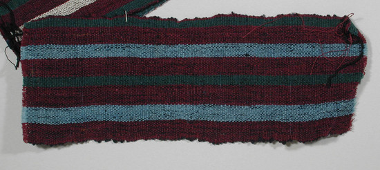 Hearst Museum object titled Textile fragment, accession number 5-11273, described as textile sample (section of narrow band weaving): four maroon stripes, two  green stripes, two pale blue stripes.