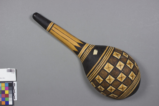 Hearst Museum object titled Gourd ladle, accession number 5-11521, described as Gourd ladle, Nigeria, Haussa att. July 27, 1972. 5-11521, acc no. 2879, file code 1.5. Collector: T.D. Lanagan. Donor: W.H. Lawson. Materials, techniques: spoon shape from 1/2 of gourd; designs pyroengraved on all surfaces; Context of use: for eating or serving liquid foods Description: Spoon or ladle, made from gourd; designs mainly pyroengraved; bottom of bowl has as leading designs squares of "x's" alternating with squares of grid bounded by band of 3 black lines; all surfaces are decorated; 39.5 cm. l.; 14.8 cm. w.;