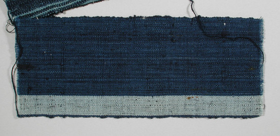 Hearst Museum object titled Textile fragment, accession number 5-11142, described as Textile sample (section of narrow band weaving): cotton; blue ground; one light blue stripe by edge.