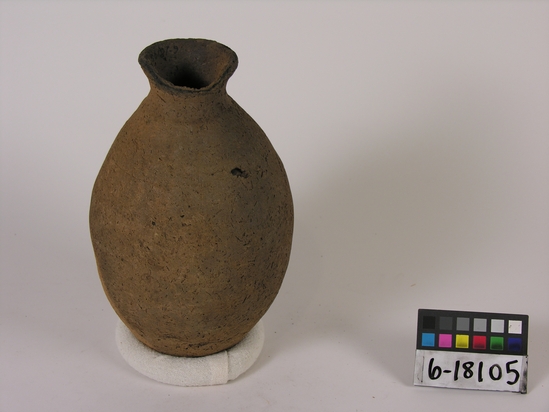 Hearst Museum object titled Broken bottle, accession number 6-18105, described as Pottery: brown bottle, crude, neck broken; least diameter 6 cm, greatest diameter 13 1/2 cm, height 24 cm.