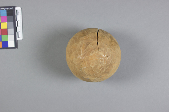 Hearst Museum object 2 of 2 titled Wooden sphere, accession number 11-39498, described as Ball; oval wood; split; for adult; used in game similar to bowling (ball tossed at a target; ball is to get as close to object as possible)