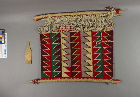 Hearst Museum object titled Blanket and loom model, accession number 2-13442a,b, described as Textile has varicolored outlined serrates.  a) Model blanket and loom; b) comb.