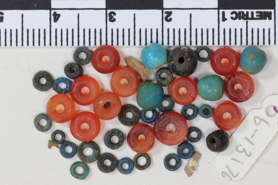 Hearst Museum object 4 of 10 titled Beads, accession number 6-13176, described as Beads: 15 green glaze, various, 12 carnelian discs, 26 green. [inv.: ball and ring beads, original object count: 53?]