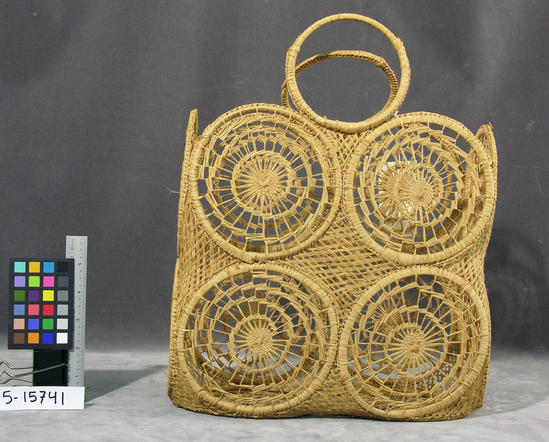 Hearst Museum object titled Basket, accession number 5-15741, described as Carrying basket, fiber, square, without lid; wrapped (bamboo?) rings, with spiraling openwork designs; sewn together, four rings per side, two at bottom and two at each end; two-ring open ring handle; natural color; length (without handle) 27.3 centimeters X width 27.3 centimeters X height 14.0 centimeters.