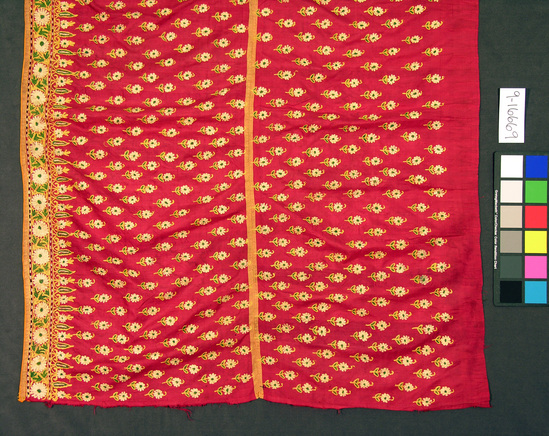 Hearst Museum object titled Skirt, accession number 9-15669, described as Shirt, "ghagra".  Silk, cotton border lining.  Plain weave, embroidered, plain weave binding.  Red ground, white, yellow and green designs.  Orange binding.  Flower motives (Phulkari).  3 yards, 13 inches by 35 inches.