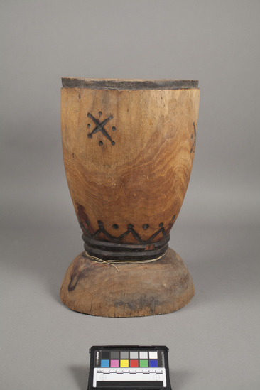 Hearst Museum object titled Mortar, accession number 5-9930, described as Mortar; wood; goblet shape with pedestal base; pyro-engraved triangle, dot design near base; 4-pyro-engraved "X" encircled with dots on body; ht. 45 cm; diam. 27.5 cm.