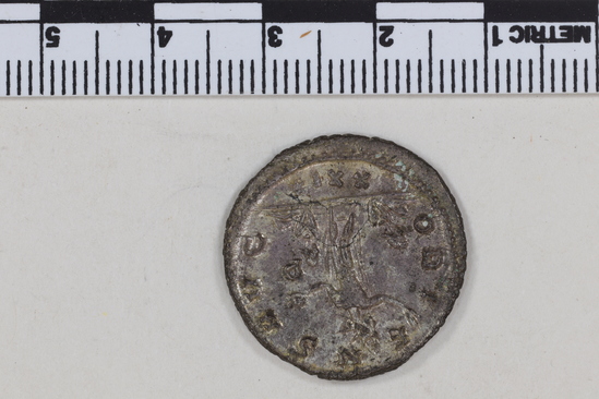 Hearst Museum object 6 of 8 titled Coin: billon antoninianus, accession number 8-4038, described as Coin; AG; Billon. Antoninianus; Roman. Aurelian, 270-275 AD. Obverse: IMP AVRELIANVS AVG, Bust r. radiate. Reverse: ORIENS AVG, Sol standing holding globe between two captives, IP, XXI* in field