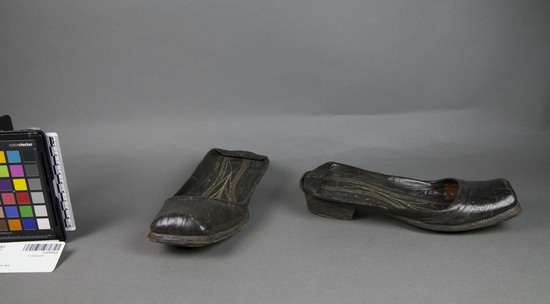 Hearst Museum object 2 of 2 titled Shoes, accession number 9-22543a,b, described as brown leather shoes with square toes and 2.5 cm high heels of stacked leather.  leather insole sewn with a decorative pattern in white thread.  backs have been walked down to make the shoes slip-ons.