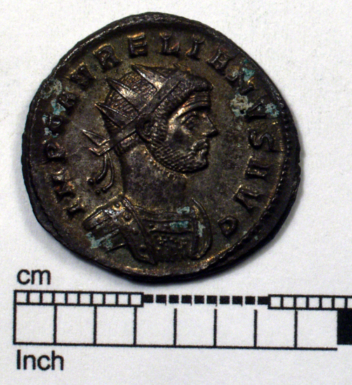 Hearst Museum object 1 of 6 titled Coin: billon antoninianus, accession number 8-4047, described as Coin; AG; Billon. Antoninianus; Roman. 4.18 grams, 23 mm. Aurelian, 270-275 AD. Obverse: IMP AVRELIANVS AVG, Bust r. radiate. Reverse: ORIENS AVG, Sol striding l., two captives at his feet; T in field r., in exergue SXXT