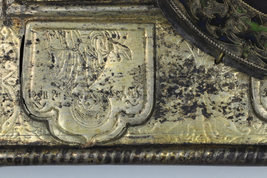 Hearst Museum object 26 of 49 titled Icon, accession number 7-3541, described as Icon of “Our lady of Vladmir”; Virgin and Child in tempera and gesso on wood; gilded silver basma; cloisonne halo with cloisonne collar pendant; halo has glass and amber (?) ornamentation; Virgin’s face damaged; height 30.2 cm, width 26 cm.