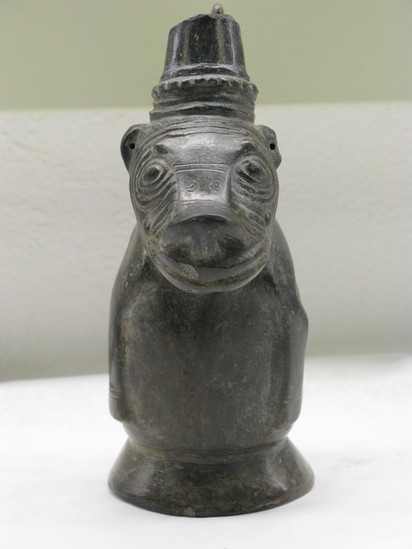 Hearst Museum object 4 of 5 titled Effigy jar, accession number 16-18195, described as Effigy jar, zoomorphic; squatting dog in black ware; strap handle with modeled animal; damaged ring base, damaged spout; height: 16 cm.