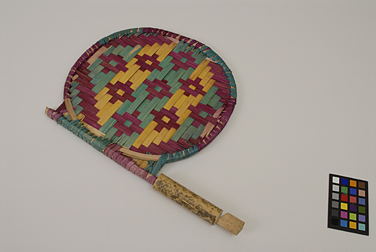 Hearst Museum object titled Fan, accession number 9-10956, described as fan, hand; date palm straw, bamboo; green, yellow, purple; 32.5 cm length; 25.5 cm width