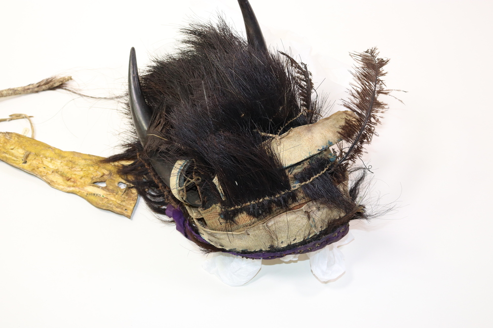 Hearst Museum object titled Headdress, accession number 2-19595, described as Buffalo. Foundation is European felt hat; decorated with rawhide strips; horsehair tufts; woven European band; purple sequined ribbon; 2 buffalo horns; rawhide trailer.