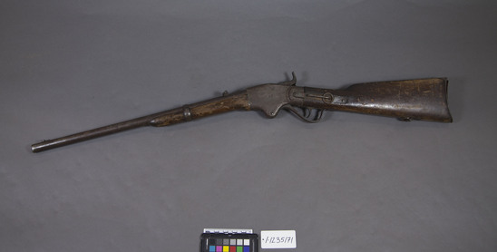 Hearst Museum object titled Rifle, accession number 1-235171, described as rifle, breech loading. Spencer breech loading repeating carbine, caliber .54 rimfire. Lever action, dropping block, 7 round magazine in buttstock. Serial No. 46469.