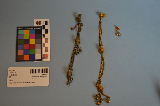 Hearst Museum object titled Buttons, accession number 9-23390, described as 3 bars with flat backs and a bird design front joined by chains. 2 small bells hanging from each, bronze - colored.