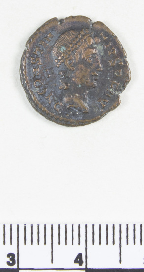 Hearst Museum object titled Coin: æ 4, accession number 8-6958, described as Coin: Aes Folles; Æ; size: 17.5 mm; weight: 2.12 grams; condition: good. Obverse: head turned right, with double pearl diadem; inscription: DN CONSTAN  TIUS  PF AUG. Reverse: wreath with inscription, VOT/X X/MULT/XXX; in exergue, SMALL.