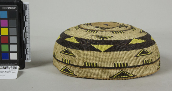 Hearst Museum object 2 of 2 titled Cap, accession number 1-226437, described as Basketry. Aberrant shape. Twined with overlay designs including yellow dyed porcupine quills in yellow and brown. Yellow triangles.  Tag "Klamath R. tribes att.". Per Ralph Shanks:  Twined woman's basket hat, apparently never worn.  Crossed warp starting knot with an overlay of maidenhair fern.  The warp material is possibly willow. The weft material is conifer root.  The weft overlay design has a beargrass background with maidenhair fern and yellow-dyed porcupine quill designs. Starting at the starting knot, there are two weft rows of plain twining followed by 3/4 inch of three strand twining followed by 3/4 inch of plain twining, followed by one weft row of three strand twining.  Plain twining continues to the rim where there is one weft row of three strand twining 1/2 inch below the rim.  The rim is trimmed but the warps sticks protrude 1/25th of an inch.  The main design is a horizontal band with triangles inside and to the top and bottom of the band.  The basket has a rightward work direction, with an up to the right slant of weft twist.  The workface is on the exterior.  The overlay is single-sided, with the design on the exterior.  The basket is from Northwestern California, it is not a standard sized basket hat.  Based on the U.S. Indian Census Schedules, 1885-1940 Ida Harry, the maker of this hat, was the daughter of Waukell Harry, a Yurok tribal member.