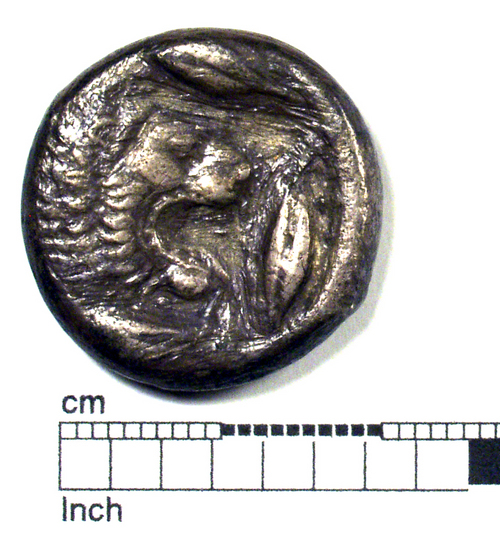 Hearst Museum object titled Coin: ar tetradrachm, accession number 8-5821, described as Coin: AR; Tetradrachm; size: 23 mm.: weight 16.1 gm. Obverse: Lion’s head r., with open mouth; around, four barley-corns. Reverse: Quadrigq r., driven by male charioteer, who holds reins in both hands; horses walking; above, Nike flying r., cr(?)owning horses; broder of dots