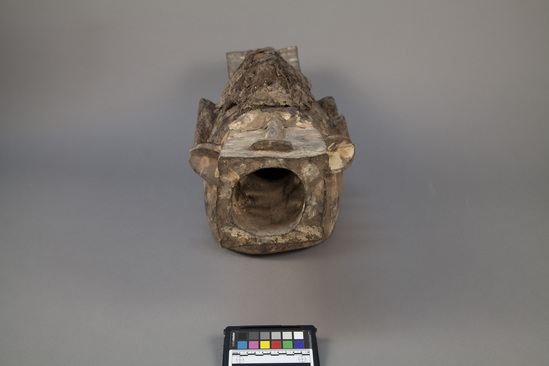 Hearst Museum object titled Helmet mask, accession number 5-5341, described as Two-faced, carved, wooden, “fire spitters”,helmet mask. Painted dot decoration. On top is fiberous mastic with remains of feathers.L = 65.0 cm