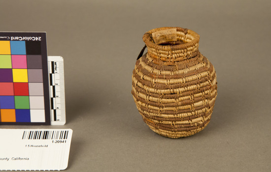 Hearst Museum object 2 of 2 titled Basket, accession number 1-20941, described as Jar basket; coiled. Warp is Epicampes (Sporobolus rigens), weft is Willow (Salix). Red pattern is Yucca. Neck coiled basket with interrupted stitch; coils alternating brown and white.