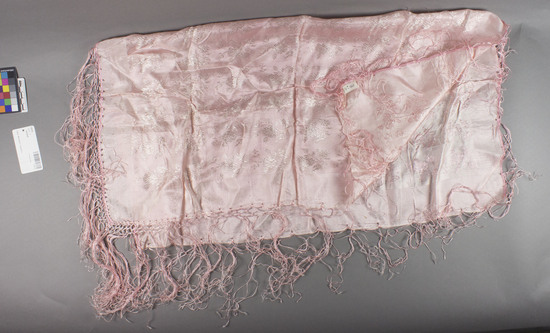 Hearst Museum object titled Kerchief, accession number 7-5115, described as Woman’s silk kerchief ( svilena marama- “ silk kerchief”; marama is Turkish); worn as a decorative apron; pink, with fringe; 26 3/4 inches wide; 28 inches long