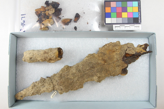 Hearst Museum object titled Spearhead, accession number 8-1671, described as Spearhead and spear shoe (large fragments and dust). Description from Matteucig (1951): Iron spear in two fragments with remains of wooden handle. Length, 38.5 cm (see Matteucig's plate XXIII, 9).