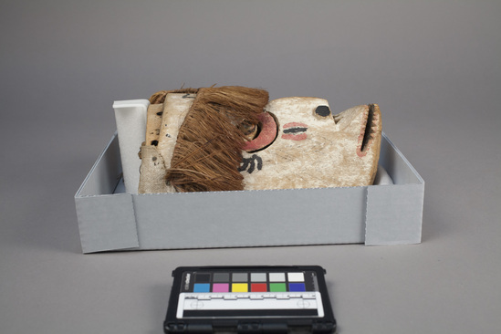 Hearst Museum object 2 of 2 titled Mask, accession number 11-42718, described as Mask, carved wood, white painted face with red and black; mouth broken and repaired; attached fiber head band. 25.0 cm. Used in ceremonial dance.