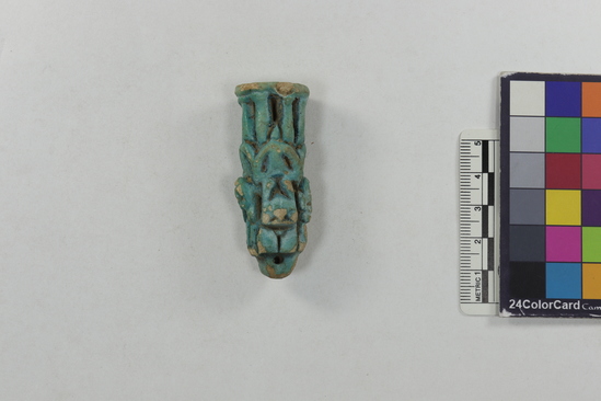 Hearst Museum object 4 of 11 titled Amulet (gods), accession number 6-22068, described as Four-sided amulet of blue faience, showing faience, showing Horus (two sides), Harpocrates, and Serket; length 56 mm.