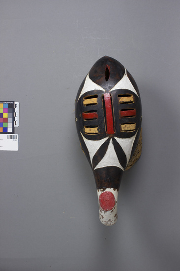 Hearst Museum object titled Mask, accession number 5-1951, described as Ceremonial headmask; incised gourd painting black with incised white designs-elephant? basketry backing; length 13 ½ inches; wide 6 inches. Made by local carver; Chukwu Okoro.