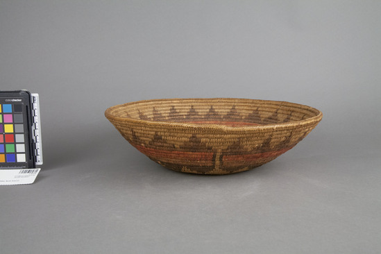 Hearst Museum object 2 of 3 titled Basket, accession number 2-50120, described as Coiled, basin shaped. Straw colored star in center; encircling red bands with triangular designs in brown above and below.