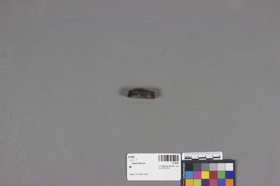 Hearst Museum object titled Sword hilt rim, accession number 9-2056, described as Sword hiltrim; slotted oval; iron; floral design; gold sheeting; 3.9 x 2.3 x 1 cm