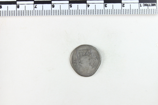 Hearst Museum object 6 of 8 titled Coin: ar denarius, accession number 8-4690, described as Coin; AR; Denarius; Roman. Vespasian, 74 AD. Rome, Italy. Obverse: IMP CAESAR ___ ___, bust r. laureate. Reverse: COS V; to left and right, two laurel branches. CF American Numismatic Society coin 1985.140.42 with inscription Obverse: IMP CAESAR VESP AVG. Reverse: COS V.