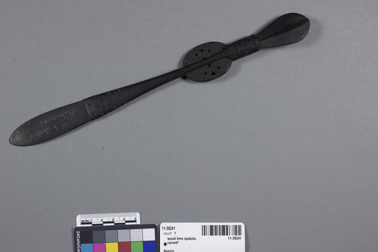 Hearst Museum object titled Lime spatula, accession number 11-39241, described as Lime spatula; carved black ebony; 4-vaned finial and two lateral crests with relief-carved frigate bird design; used for dipping lime from a gourd container to add to each chew of betel nut.